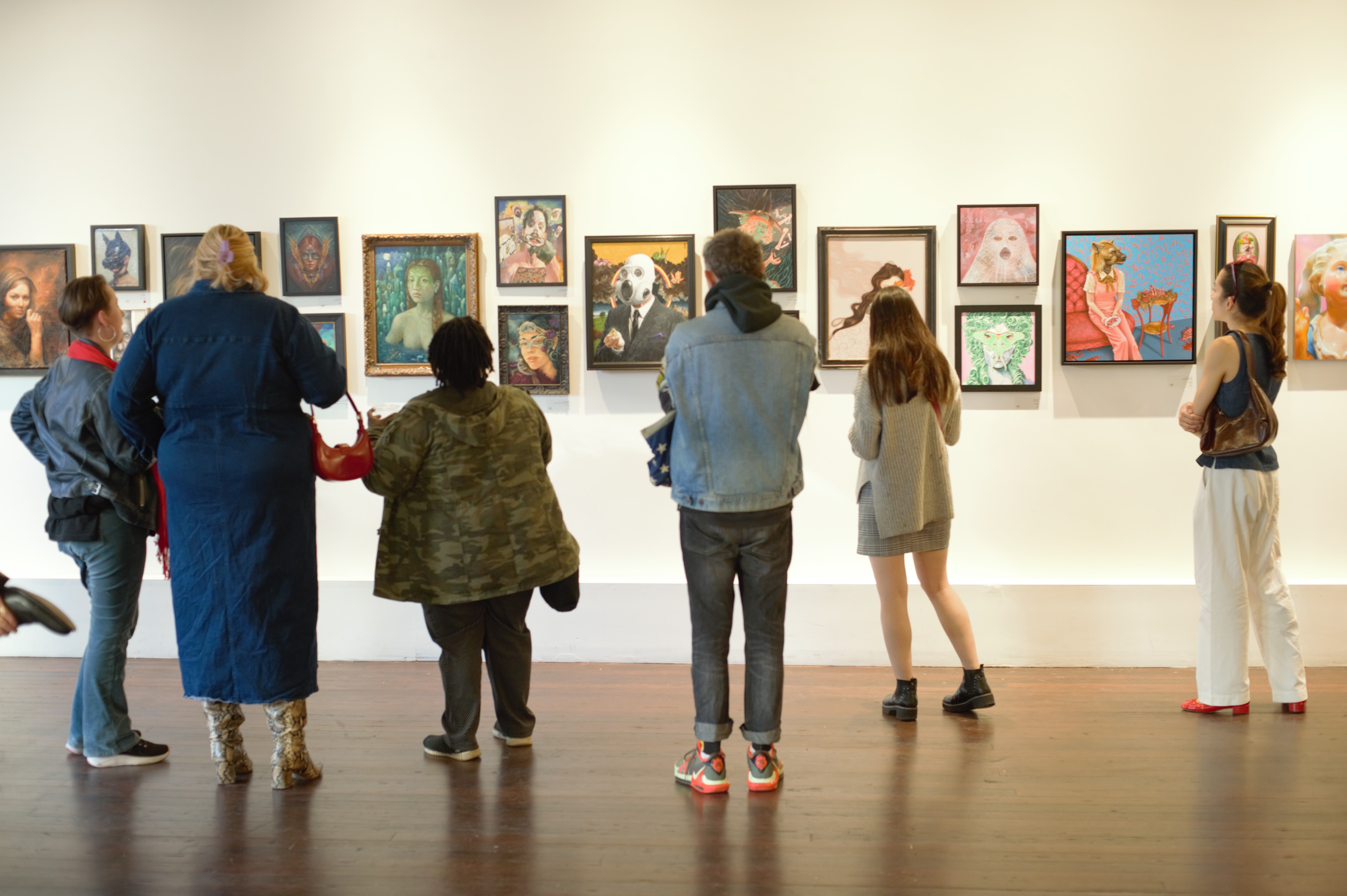 Visitors viewing artwork at a gallery opening